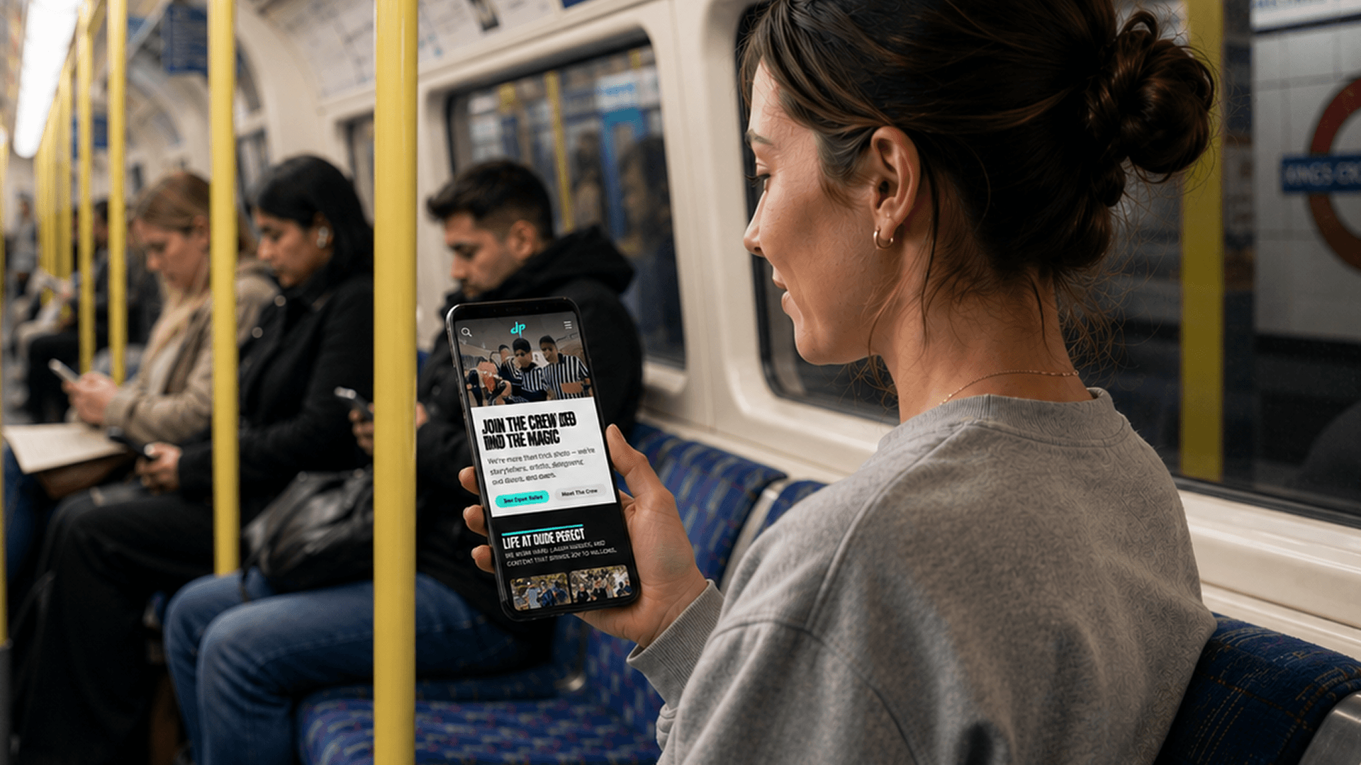 Dude Perfect fan browsing the membership platform on her phone while travelling on the London Underground.