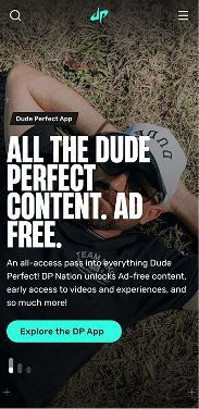 Dude Perfect mobile homepage featuring a member of the group relaxing on grass, with a headline promoting ad-free content and a link to explore the app.